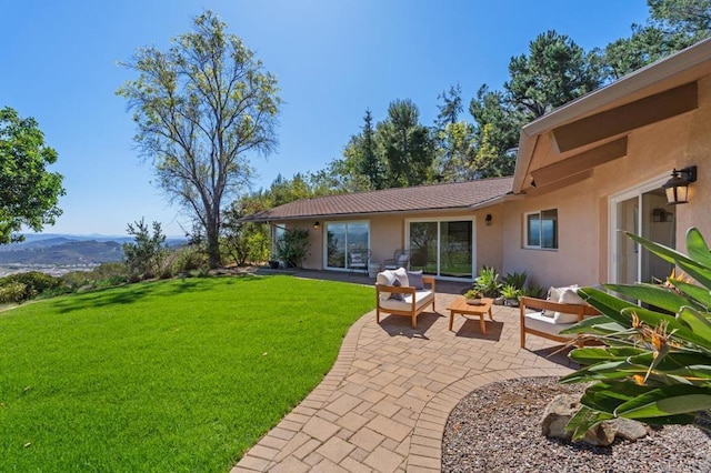 view of yard with a mountain view, a patio, and outdoor lounge area