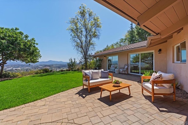 view of patio / terrace with outdoor lounge area and a mountain view