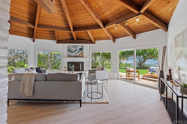 living room featuring a glass covered fireplace, wood finished floors, high vaulted ceiling, and wooden ceiling