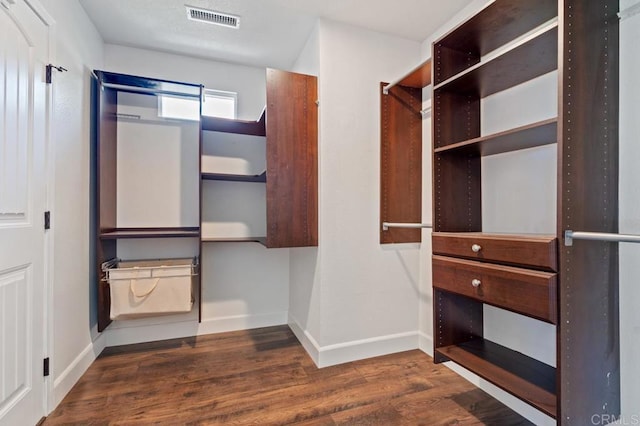 spacious closet with visible vents and dark wood-style flooring