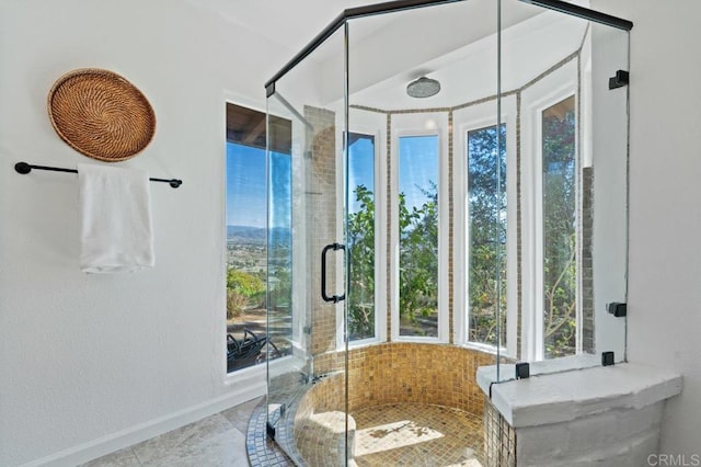 bathroom featuring baseboards and a shower stall