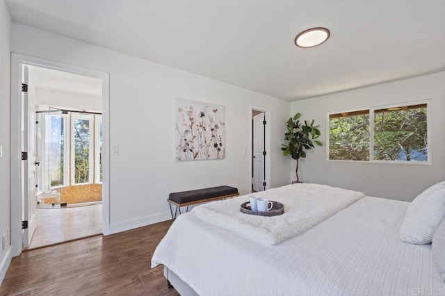 bedroom featuring dark wood-style floors and baseboards