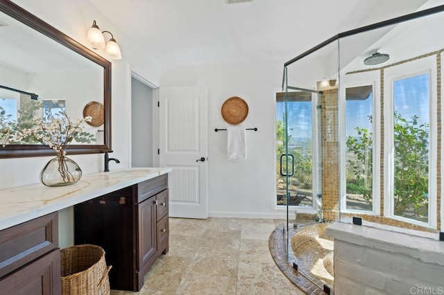 full bathroom featuring a shower stall, vanity, and baseboards