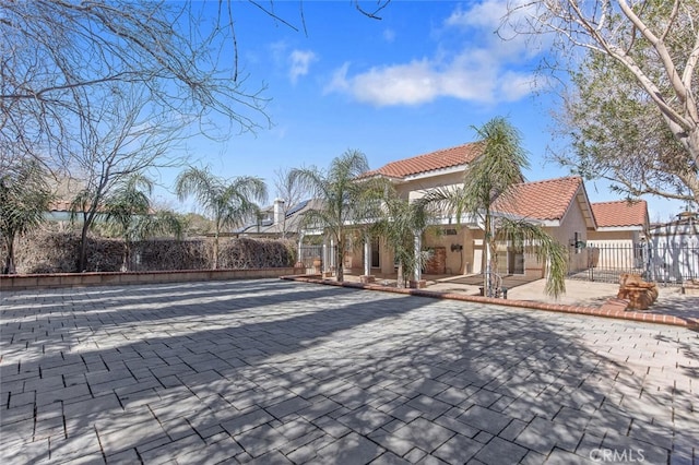 view of community featuring a patio, fence, and a residential view