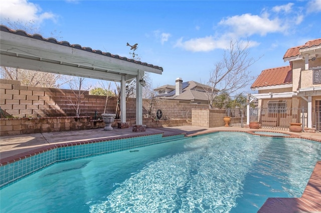 view of swimming pool featuring a fenced backyard, a fenced in pool, and an in ground hot tub