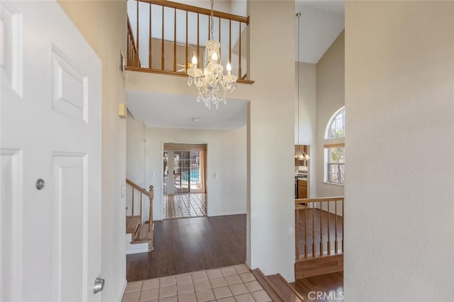 6118 Landau Pl, Quartz Hill, CA 93536 - entryway with a chandelier, a towering ceiling, healthy amount of natural light, tile patterned floors, and stairway