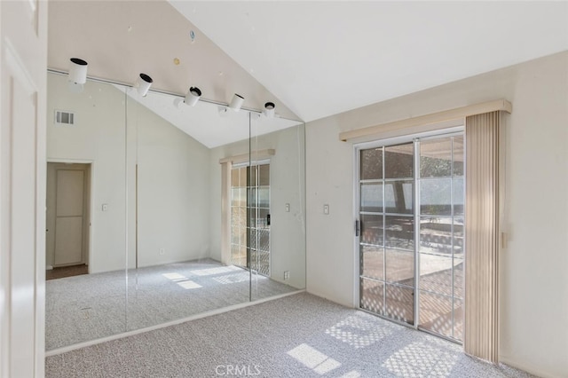 unfurnished bedroom with high vaulted ceiling, access to exterior, visible vents, and carpet flooring