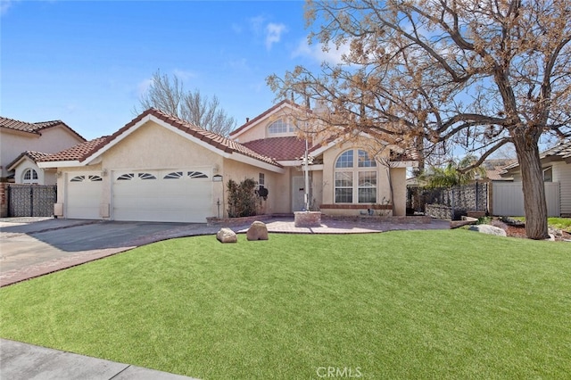 mediterranean / spanish house with a garage, concrete driveway, fence, and stucco siding