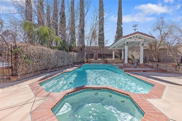 view of pool with a patio area, a fenced backyard, and a pool with connected hot tub