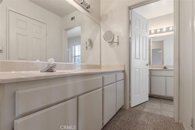 bathroom with visible vents, tile patterned flooring, and vanity