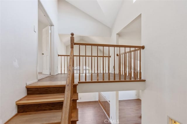 6118 Landau Pl, Quartz Hill, CA 93536 - stairs featuring lofted ceiling and wood finished floors