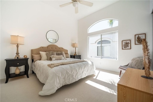 bedroom featuring light colored carpet and a ceiling fan