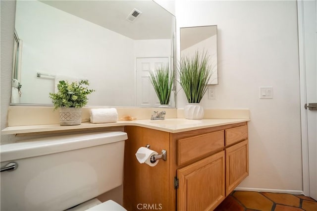 bathroom with vanity, tile patterned floors, toilet, and visible vents