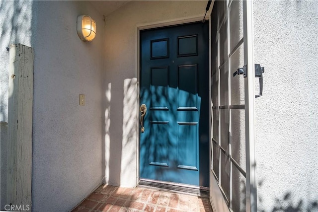 entrance to property with stucco siding