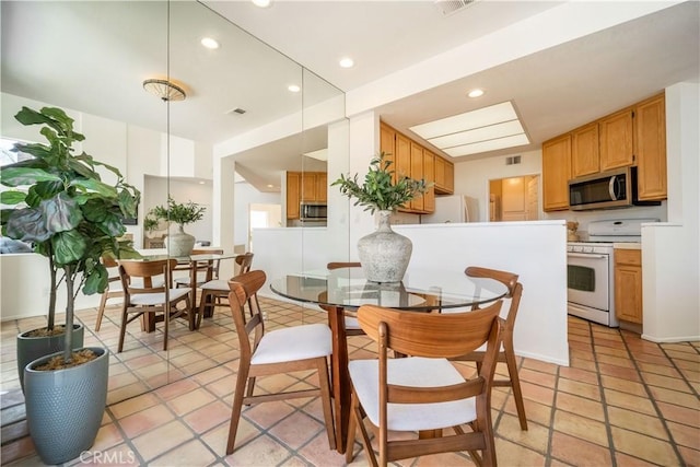 interior space with visible vents, recessed lighting, white appliances, and light countertops