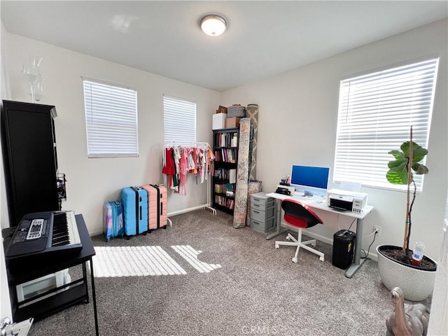 home office featuring carpet floors, a healthy amount of sunlight, and baseboards