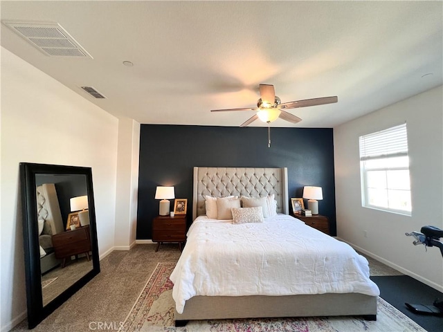 carpeted bedroom featuring visible vents, ceiling fan, and baseboards