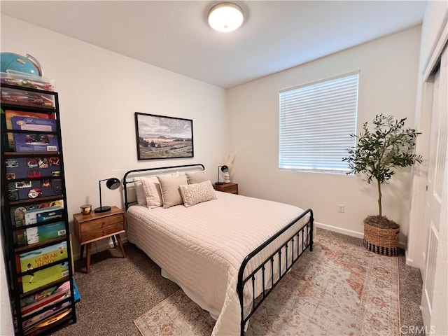 carpeted bedroom with baseboards