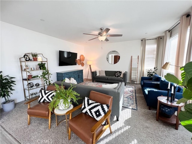 living room featuring ceiling fan and baseboards