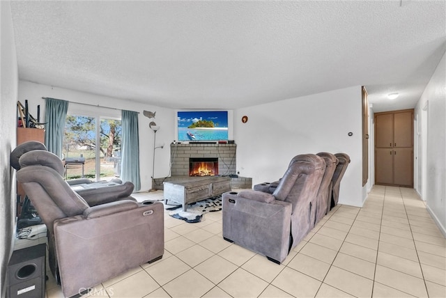 living room with light tile patterned floors, a textured ceiling, and a brick fireplace