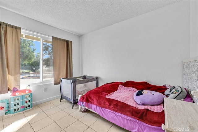 tiled bedroom featuring a textured ceiling