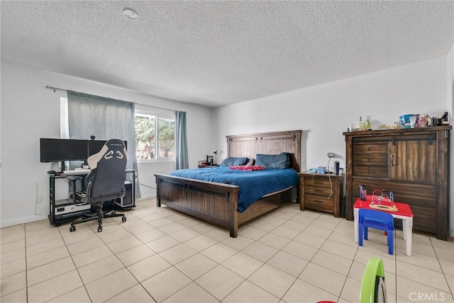 bedroom with a textured ceiling, light tile patterned flooring, and baseboards