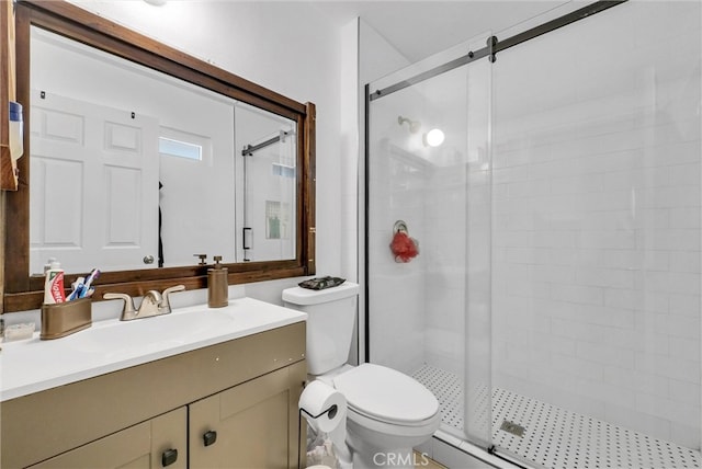 bathroom featuring toilet, a stall shower, and vanity