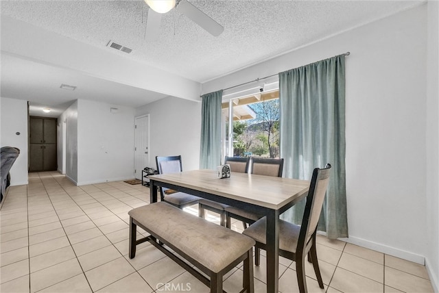 dining area with baseboards, visible vents, a ceiling fan, a textured ceiling, and light tile patterned flooring