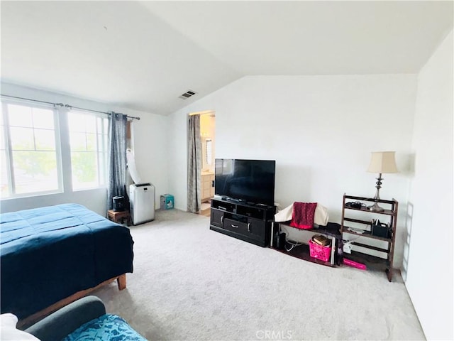 bedroom featuring lofted ceiling, carpet, and visible vents