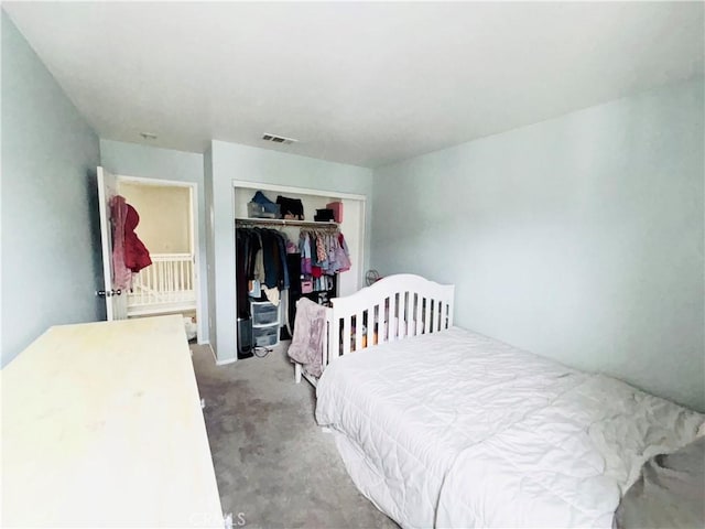 bedroom featuring visible vents, a closet, and carpet floors