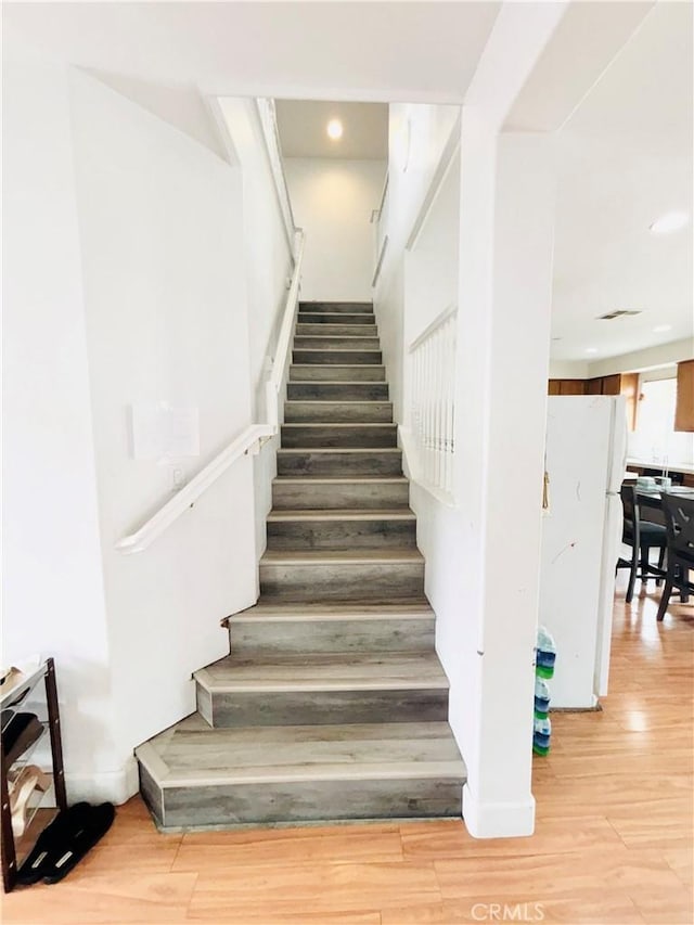 stairs with wood finished floors