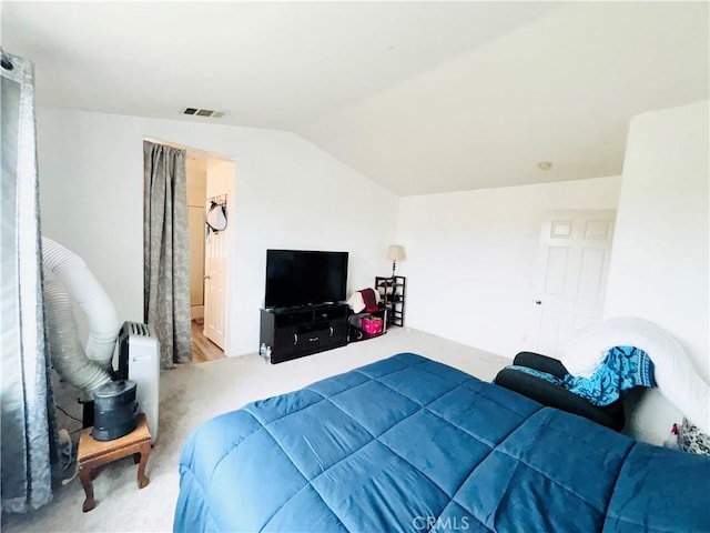 bedroom with visible vents, carpet, and lofted ceiling