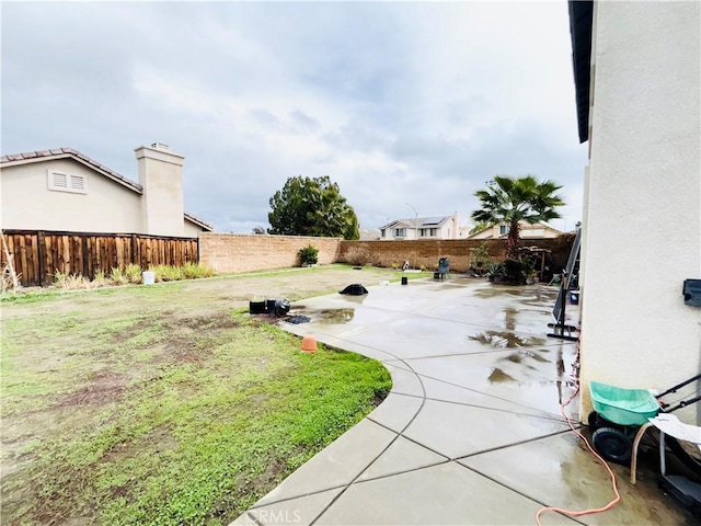 view of yard featuring a patio area and a fenced backyard