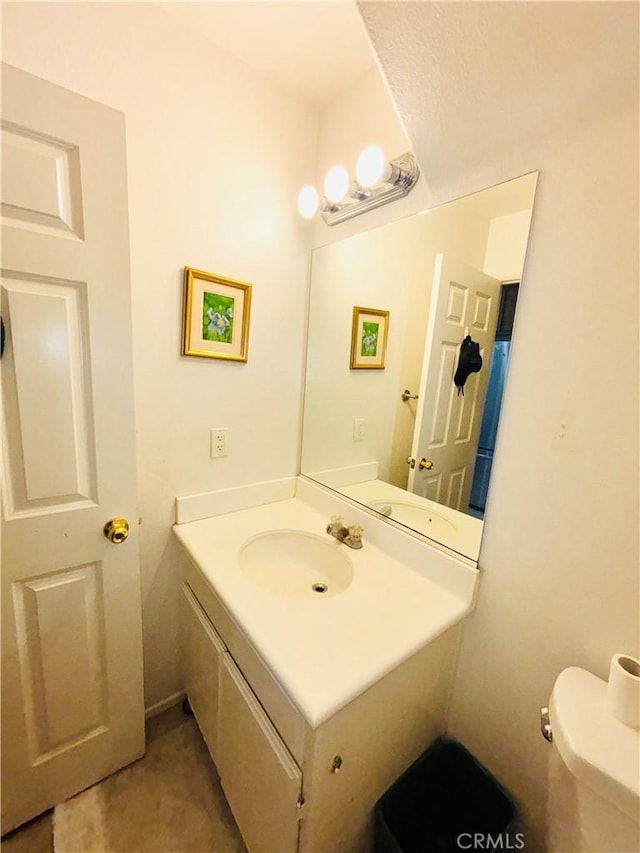 bathroom featuring toilet and vanity