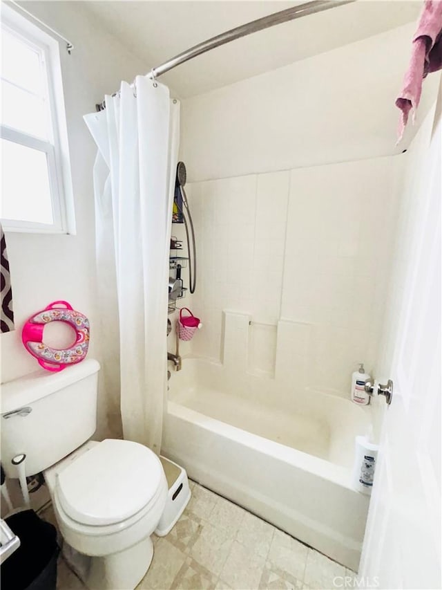 bathroom featuring tile patterned floors, toilet, and shower / tub combo with curtain