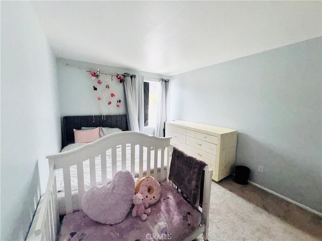 carpeted bedroom featuring baseboards