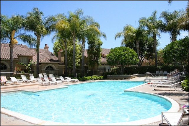 pool featuring a patio and fence