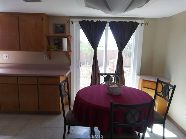 dining area featuring light tile patterned floors and baseboards