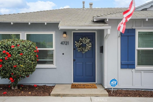 entrance to property with stucco siding