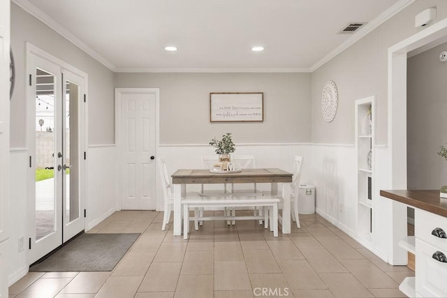 unfurnished dining area featuring visible vents, a wainscoted wall, ornamental molding, recessed lighting, and french doors