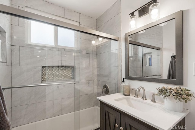 bathroom with vanity and shower / bath combination with glass door