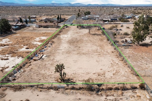 birds eye view of property with a mountain view, a desert view, and a rural view