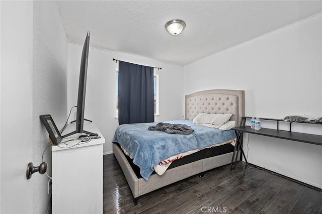 bedroom featuring a textured ceiling and wood finished floors