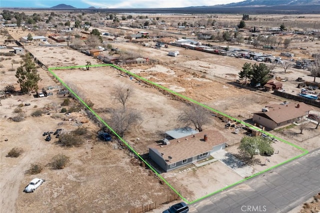 birds eye view of property with a rural view, a mountain view, and view of desert