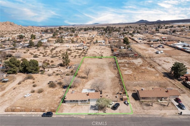 aerial view featuring a desert view and a mountain view