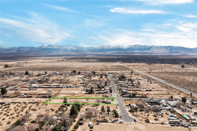 aerial view featuring a desert view and a mountain view