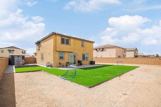 back of property with a yard, a patio, stucco siding, cooling unit, and a fenced backyard