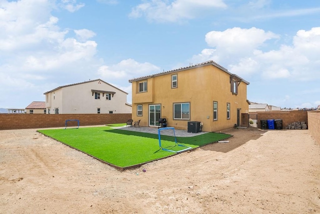 rear view of property featuring a patio, a fenced backyard, central air condition unit, a lawn, and stucco siding