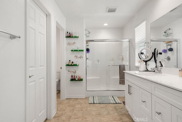 full bath featuring toilet, a stall shower, visible vents, and vanity