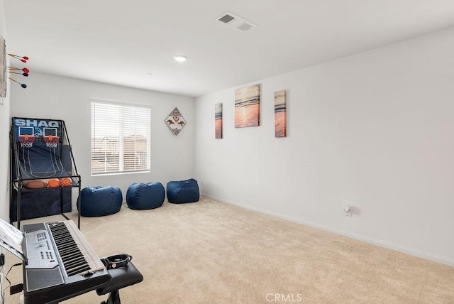 exercise area featuring carpet floors, visible vents, and baseboards